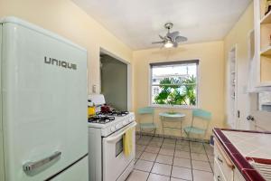 a kitchen with a white stove top oven next to a window at 167 Tamarack in Carlsbad