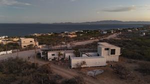 an aerial view of a town with the ocean at 20-30 Knots in El Sargento