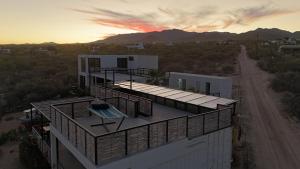 an aerial view of a building with a sunset in the background at 20-30 Knots in El Sargento