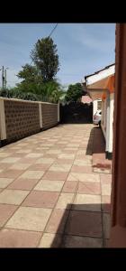 an empty sidewalk in a house with a brick wall at National Housing Estates in Kakamega