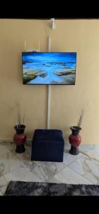 a living room with two vases and a picture on the wall at National Housing Estates in Kakamega