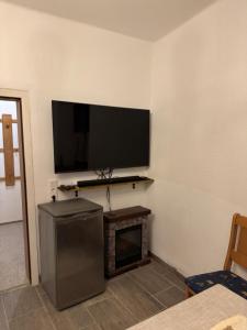 a living room with a flat screen tv on the wall at Haus mit Herz in Sulzbach-Rosenberg