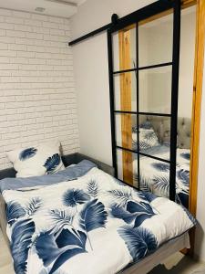a bedroom with two beds with blue and white pillows at Mieszkanie, kawalerka na wynajem kilkudniowy budynek 48 mieszkanie nr20 in Lubawa