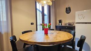 a dining room with a wooden table with chairs at Casa Artemisia in Canale +10 photos
