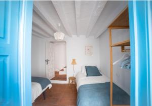 sypialnia z dwoma łóżkami w pokoju w obiekcie La Montsiña, acogedora casa de estilo mediterráneo w mieście Cómpeta