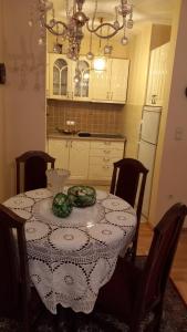a kitchen with a table with a plate of vegetables on it at Apartman DIMITRIJEVIC in Šabac