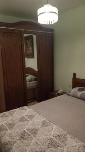a bedroom with a bed and a chandelier at Apartman DIMITRIJEVIC in Šabac +3 photos
