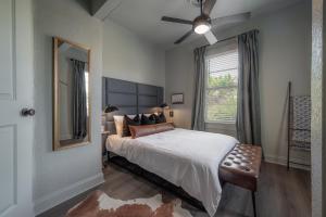 a bedroom with a bed with a ceiling fan and a window at Updated Condo in Heart of Tampa 1569 in Tampa