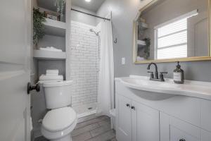 a white bathroom with a toilet and a sink at Updated Condo in Heart of Tampa 1569 in Tampa