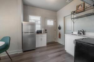 a kitchen with a stainless steel refrigerator and white cabinets at Updated Condo in Heart of Tampa 1569 in Tampa +11 photos