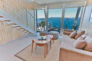 a living room with a couch and a table at Departamentos Luxe en Bariloche in San Carlos de Bariloche
