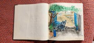 a page of an open book with a drawing of a tree at Hotel-Restaurant Le Kaouki in Sidi Kaouki