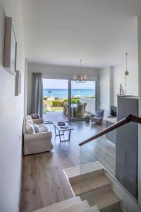 a living room with a view of the ocean at White Pearl in Hanioti