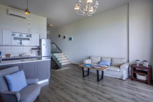 a kitchen and living room with a couch and a table at White Pearl in Hanioti +36 photos