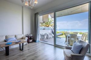 a living room with a view of the ocean at White Pearl in Hanioti