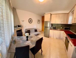 a kitchen and living room with a table and a kitchen and a couch at Kostakis House in Kalives Poligirou