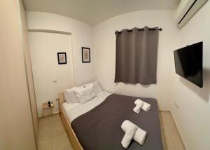 a bedroom with a bed with two towels on it at Kostakis House in Kalives Poligirou