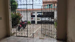 a gate with a motorcycle parked in front of a building at Mário in Una