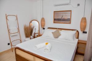 a bedroom with a bed with two towels on it at LUMA Ahangama Villa in Ahangama
