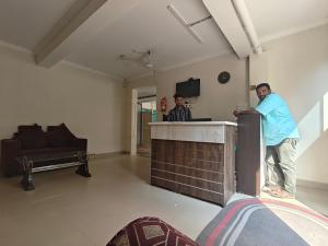 two men standing at a bar in a room at IMPERIAL Retreat in Hyderabad