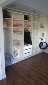a closet with white cabinets and a washing machine at Wide duplex 200 meters from the sea in Mar del Plata