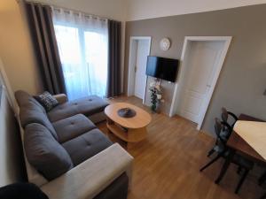 a living room with a couch and a table at Apartments Kimm's Hideaway in Poreč