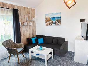 a living room with a couch and a table at Domki na Łące in Sarbinowo