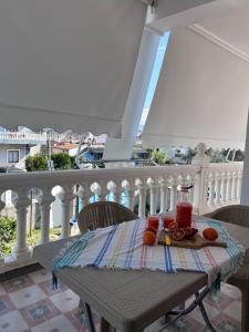 a table with a plate of fruit on a balcony at Kiki's Rooms 2 in Vlorë