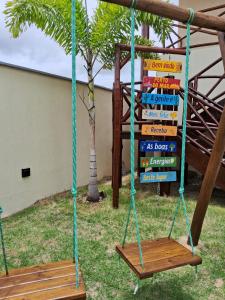 a swing with a stack of books in a yard at Villa Recanto do Mar - Icaraizinho de Amontada in Amontada