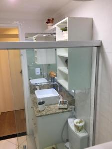 a white bathroom with a sink and a toilet at Amenity at the Best of Aracaju 2 Beds in Aracaju