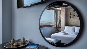 a mirror in a room with a bed and a window at Mytra Hotel in Istanbul +40 photos