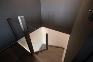 a stairwell with a glass case in a room at Mazet design vue mer 4 guests in Sainte-Maxime