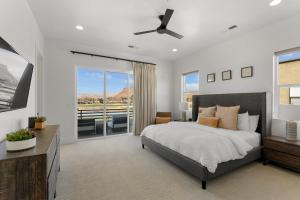 a bedroom with a bed and a balcony with a view at Villa #20 at Bloomington Country Club condo in St. George