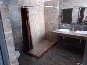 a bathroom with two sinks and a shower at Sol de México Apartments in Isla Mujeres