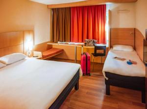 a hotel room with two beds and a desk at Valencia hotel Downtown in Cairo
