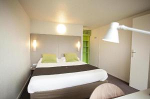 a bedroom with a large white bed with green pillows at Valencia hotel Downtown in Cairo