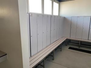 a locker room with white walls and a bench at Sailboat Anand in Lisbon