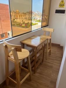 a table and two chairs in a room with a window at Hospedaje Wendy in Puerto Chicama +17 photos