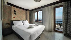 a bedroom with a large bed and a large window at Mytra Hotel in Istanbul