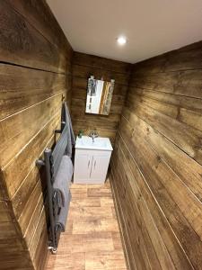a bathroom with wooden walls and a sink at Aiskew Villa Annex in Bedale +37 photos