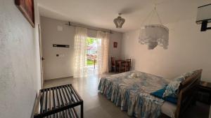 a bedroom with a bed and a table and a chair at Nosy Bay View in Nosy Be +73 photos