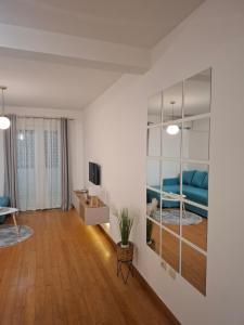 a living room with a blue couch and a television at Apartman Luka, Przno in Pržno