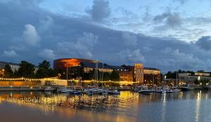 a marina with boats in the water in front of buildings at Dārza māja in Liepāja