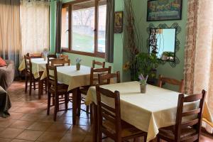a dining room with tables and chairs and a window at Guesthouse Kerkinitis in Lithótopos