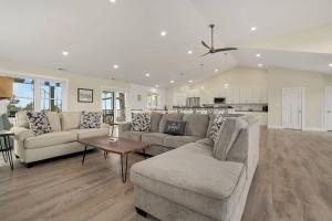 a living room with a couch and a table at Wildcat Haven - Waterfront & phenomenal views! in Deep Hole