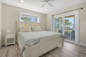 a bedroom with a large bed and a balcony at Wildcat Haven - Waterfront & phenomenal views! in Deep Hole
