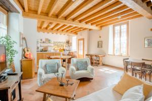 a living room with a couch and chairs and a table at Alla Torre del Barbarossa B&B FORESTERIA in Mandello del Lario