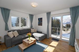 a living room with a couch and a table at SCHUSTER's ALPENPANORAMA in Seewiesen