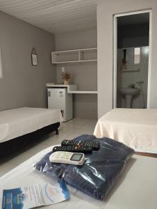 a room with two beds with remote controls on the floor at Ecovila Sertão in Petrolândia