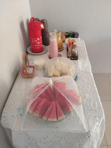 a table topped with a plastic umbrella and food at Ecovila Sertão in Petrolândia